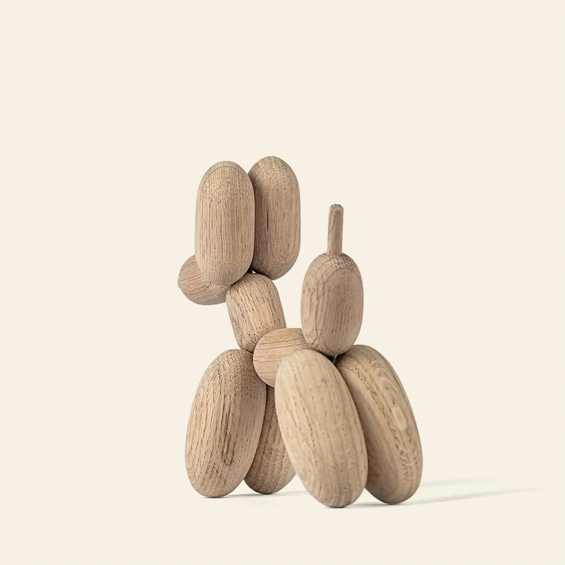 The Boyhood Ballon Dog Small by Boyhood is a small sculpture crafted from smooth European FSC-certified oak, featuring rounded shapes and minimalist design that evoke whimsical fantasy animals against an off-white background.