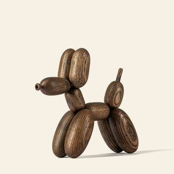 The Boyhood Ballon Dog Small by Boyhood, crafted from European FSC-certified oak, stands against a light background. Its visible grain highlights a textured, natural look inspired by whimsical fantasy animals.