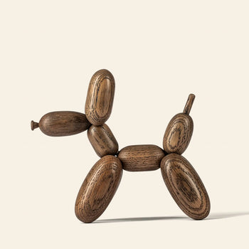 The Boyhood Ballon Dog Small by Boyhood is a wooden sculpture crafted from European FSC certified oak, featuring smooth, rounded segments that evoke whimsical balloon animals against a plain light background.