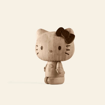 The Boyhood Hello Kitty Small by Boyhood is a wooden figurine featuring simple facial details and a dark bow on its left ear, set against a light background—a charming piece for any wooden collectibles collection.