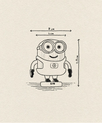 A playful hand-drawn illustration of Boyhood Minion Bob Small by Boyhood, showing Bob smiling in goggles and gloves. Dimensions: 8 cm wide, 7 cm at the head, and 11.5 cm tall.