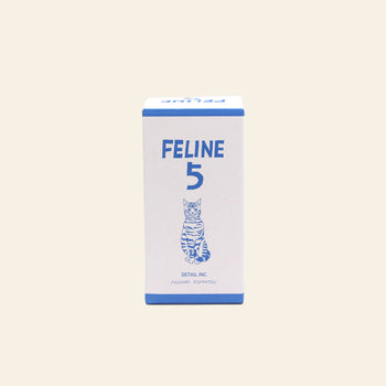 A beige rectangular box labeled DETAIL Feline 5 Nesting Dolls in blue, with a cat illustration below the text—ideal for fans of nesting dolls and cat lovers.