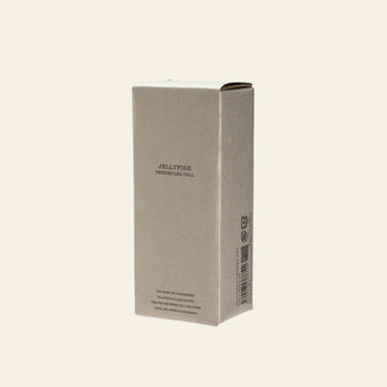 A plain, rectangular beige cardboard box with “DETAIL Jellyfish Twisted Leg Tall” printed on the front stands upright against a light background—ideal packaging for a modern art piece or tall glass décor by DETAIL.