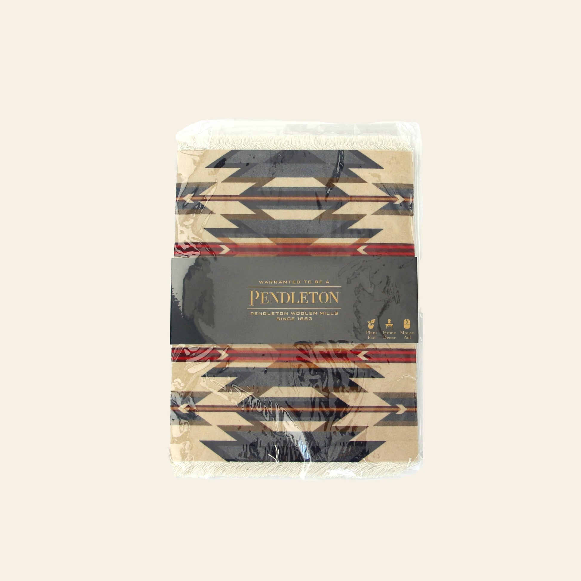 A DETAIL Mouse Rug Wyeth Trail by DETAIL, inspired by Native American carpet patterns, features a geometric black and beige design with original packaging and a dark label around the rug.