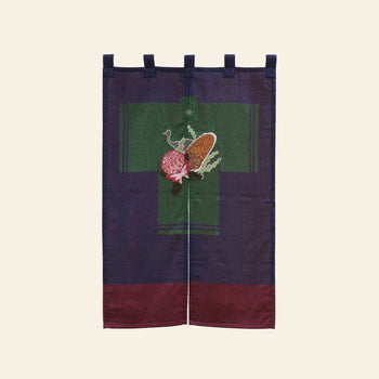 The DETAIL Noren Curtain by DETAIL features top loops, a central green cross, and embroidered pomegranate and pine cone motifs inspired by kimono patterns, with deep blue and burgundy hues for a rich, plant-themed design.