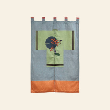 The DETAIL Noren Curtain by DETAIL has kimono patterns, a green center with a dark blue sun, orange palm trees, and orange/blue borders. It features top loops for easy hanging.