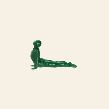 A green plastic soldier from the DETAIL Yoga Joes 9 Figures collection by DETAIL is posed in an upward yoga stretch against a beige background.