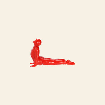 A small red plastic figure from the DETAIL Yoga Joes 9 Figures collection by DETAIL is posed in an upward stretch with arms straight and legs extended, set against a plain beige background.