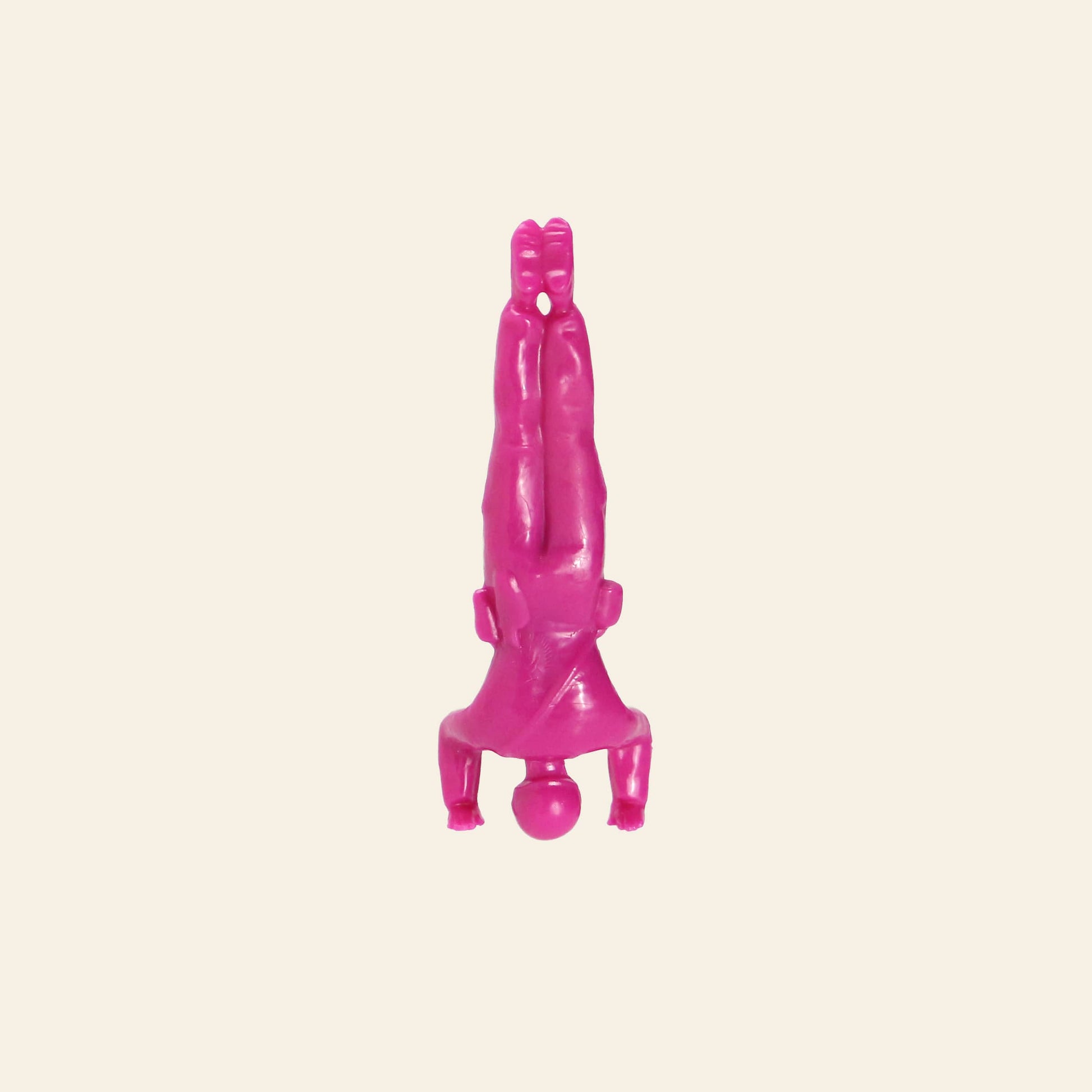 A small pink plastic figurine from DETAIL Yoga Joes 9 Figures by DETAIL shows a person in a headstand, legs together and arms bent, against a light background—ideal for Yoga Joes or toy soldier yoga enthusiasts.