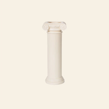 The DOIY Athena Vase by DOIY features a white, Greek-inspired Ionic column design with elegant scrolls at the top and a smooth base, standing upright against a light beige background.