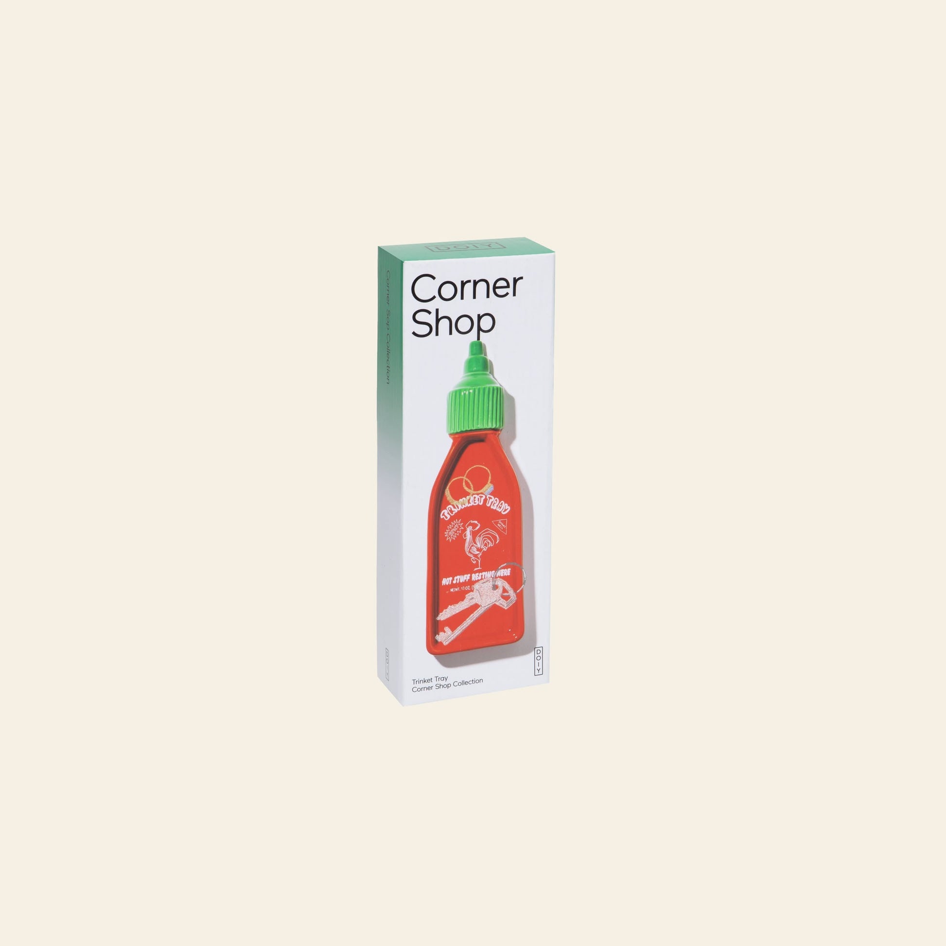 The DOIY Corner Shop Sriracha Trinket Tray by DOIY features a red hot sauce bottle with a green cap and white rooster logo, bringing retro charm to your space against a simple, light background.
