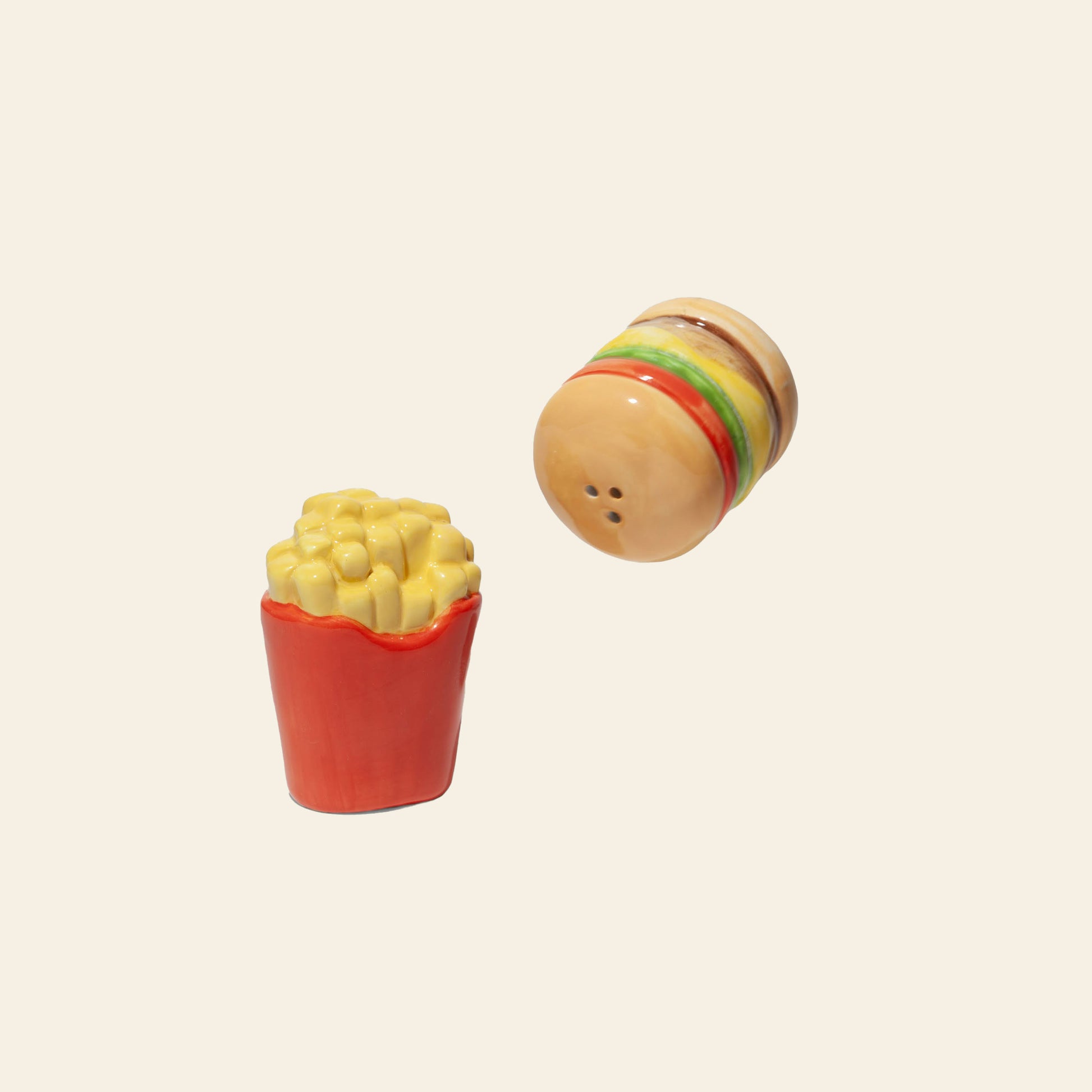 Enhance your table with the DOIY Fast Food Fries & Burger Salt & Pepper Set—ceramic shakers shaped like a fries box and cheeseburger, perfect for fans of retro kitchen style.