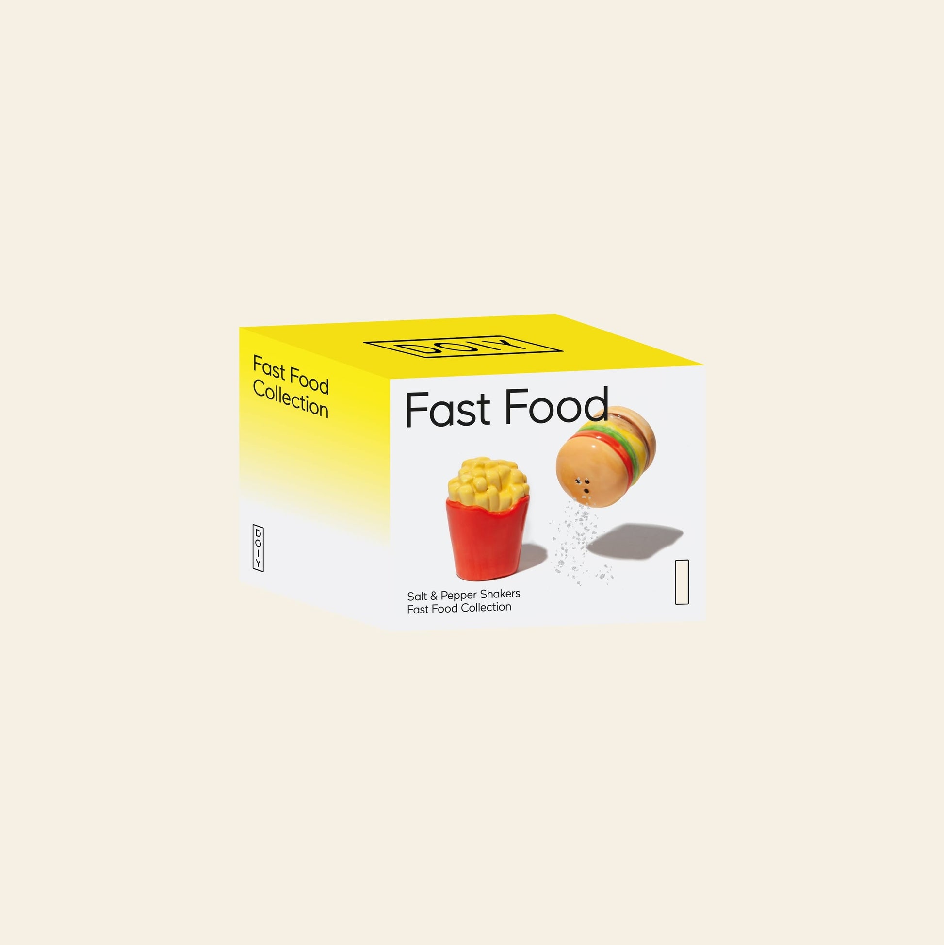A DOIY Fast Food Collection box features images of the DOIY Fast Food Fries & Burger Salt & Pepper Set, adding vintage decor charm to your kitchen with its burger and fries design on a white and yellow background.