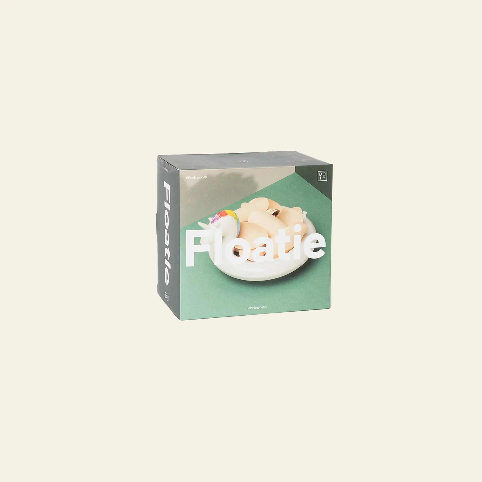 The DOIY Unicorn Floatie Bowl box shows a beige figure relaxing on a unicorn pool float in a pool with a green background and bold white text—a playful decorative accent from DOIY for any space.