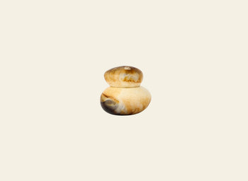 The Dinosaur Designs Small Pebble Jar by Dinosaur Designs features two smooth, rounded jars—one smaller, one larger—stacked together with brown, beige, and cream marbled patterns against a light beige background.
