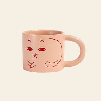The Donna Wilson Cat Mug by Donna Wilson features a light pink design with a simple red line drawing of a cats face and tail—an adorable way to add playful charm to your coffee break.
