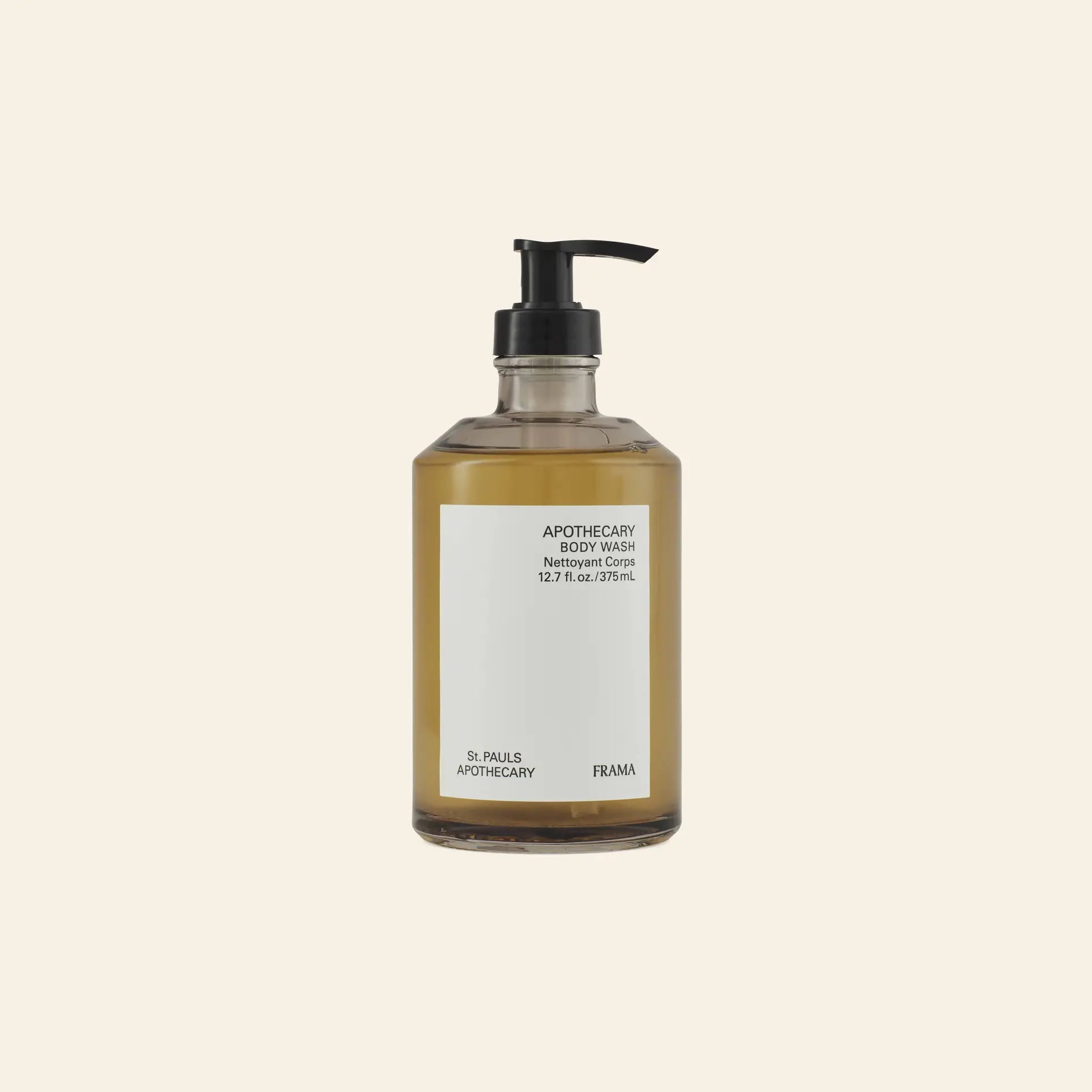 A clear pump bottle of FRAMA Body Wash, 375ml, filled with amber liquid and labeled with the brand name, sits against a light beige background, reflecting the soothing essence of FRAMA’s fragrant cleansing gel collection.