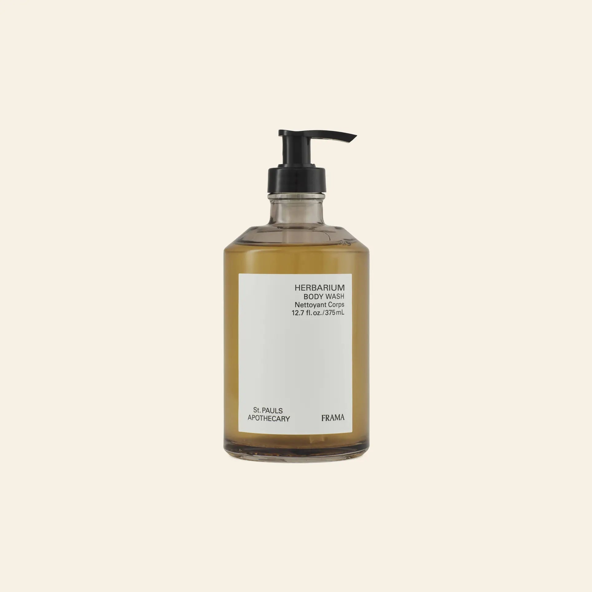 A clear pump bottle of amber FRAMA Body Wash, 375ml, is displayed against a plain beige background.