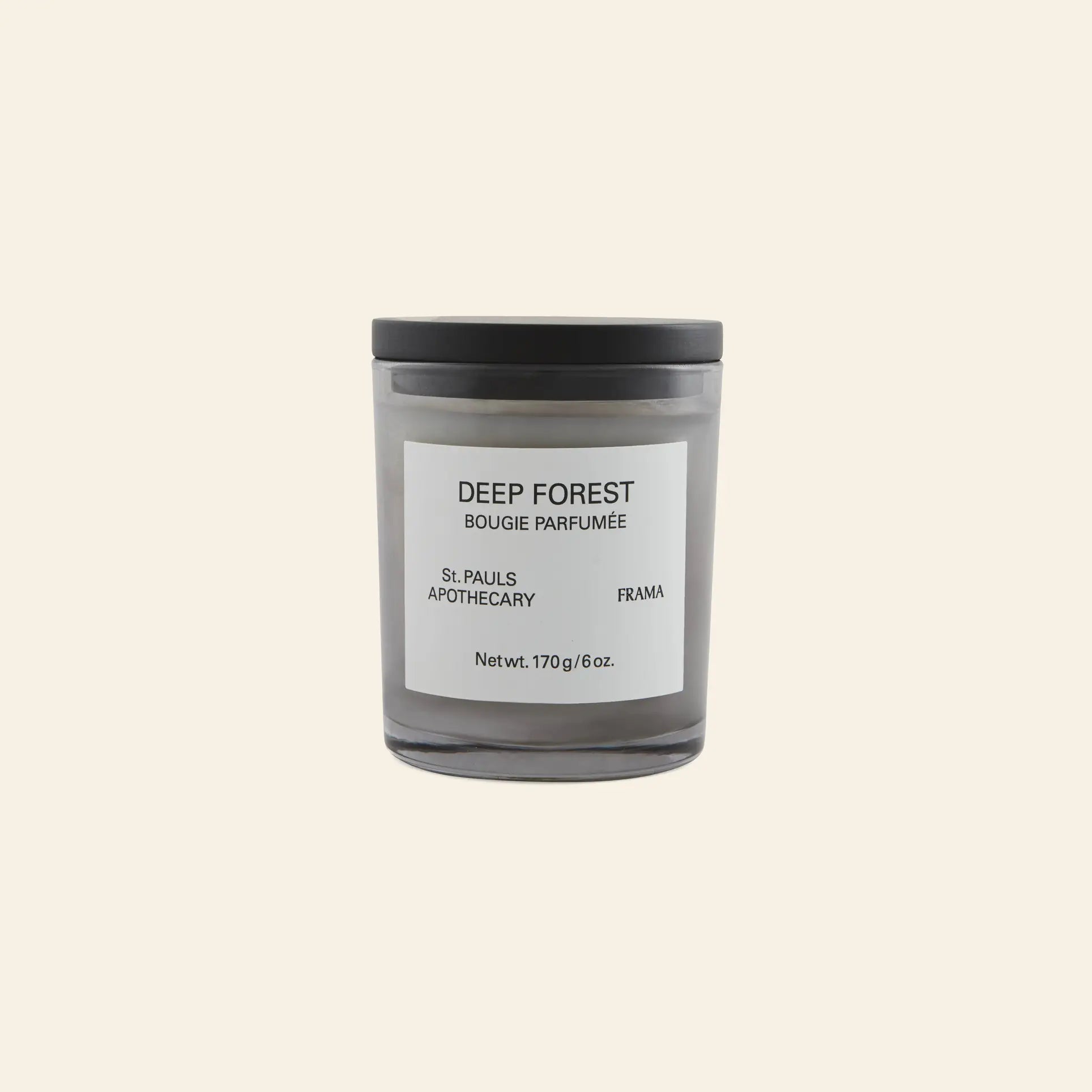 The FRAMA Deep Forest Scented Candle, 170g, comes in a black glass jar with a white DEEP FOREST label and black lid. Set against a light beige background, its earthy fragrance evokes Abies fir woods.