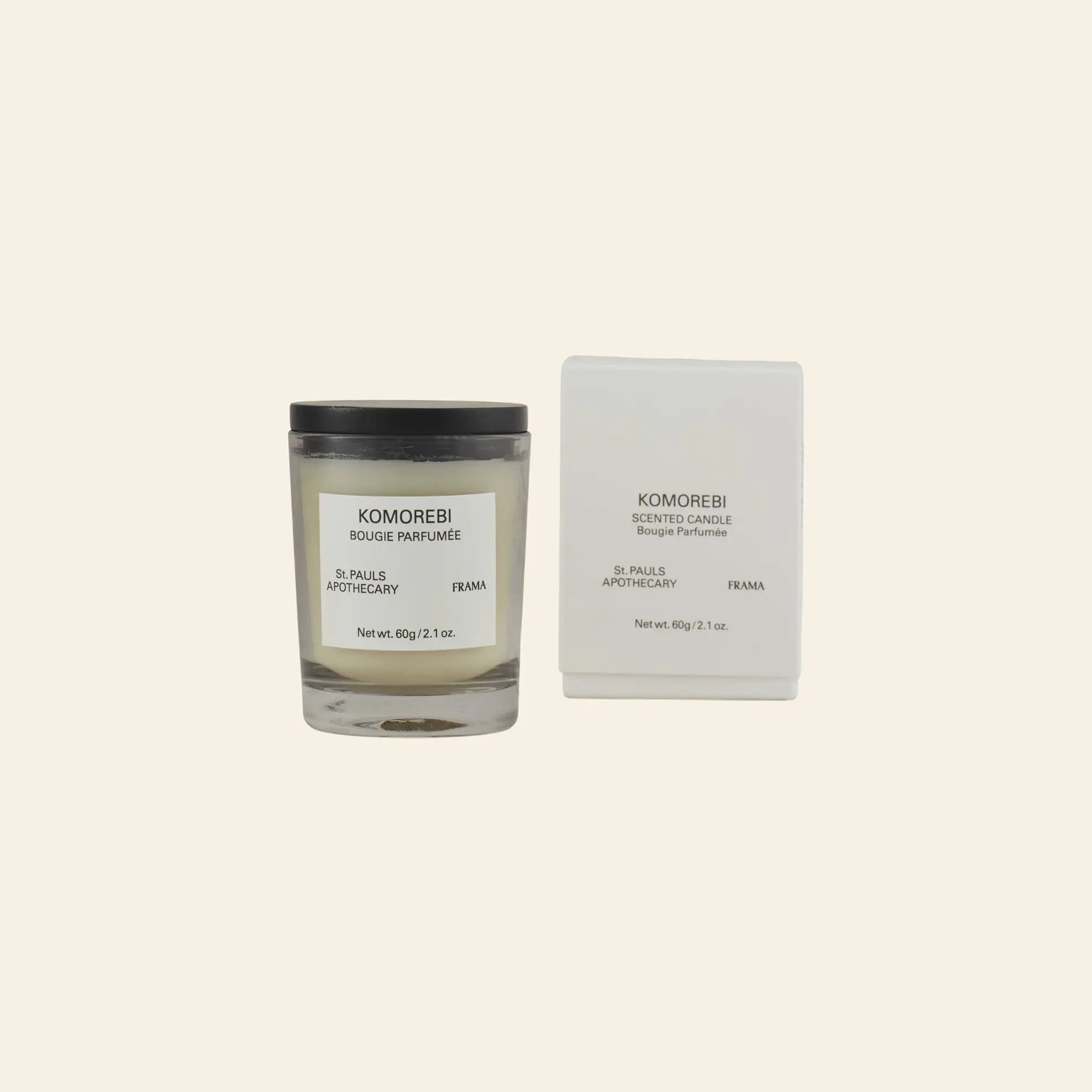 The FRAMA Komorebi Scented Candle, 60g, sits beside its matching white box—both display minimalist black text on a light background, blending modern style with a delicate floral fragrance.