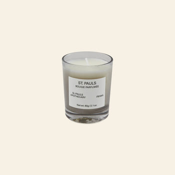 The FRAMA St. Pauls Scented Candle, 60g, features a minimalist label on clear glass. Part of the Apothecary Collection, its distinctive aroma brings sophistication and elegance to any room.