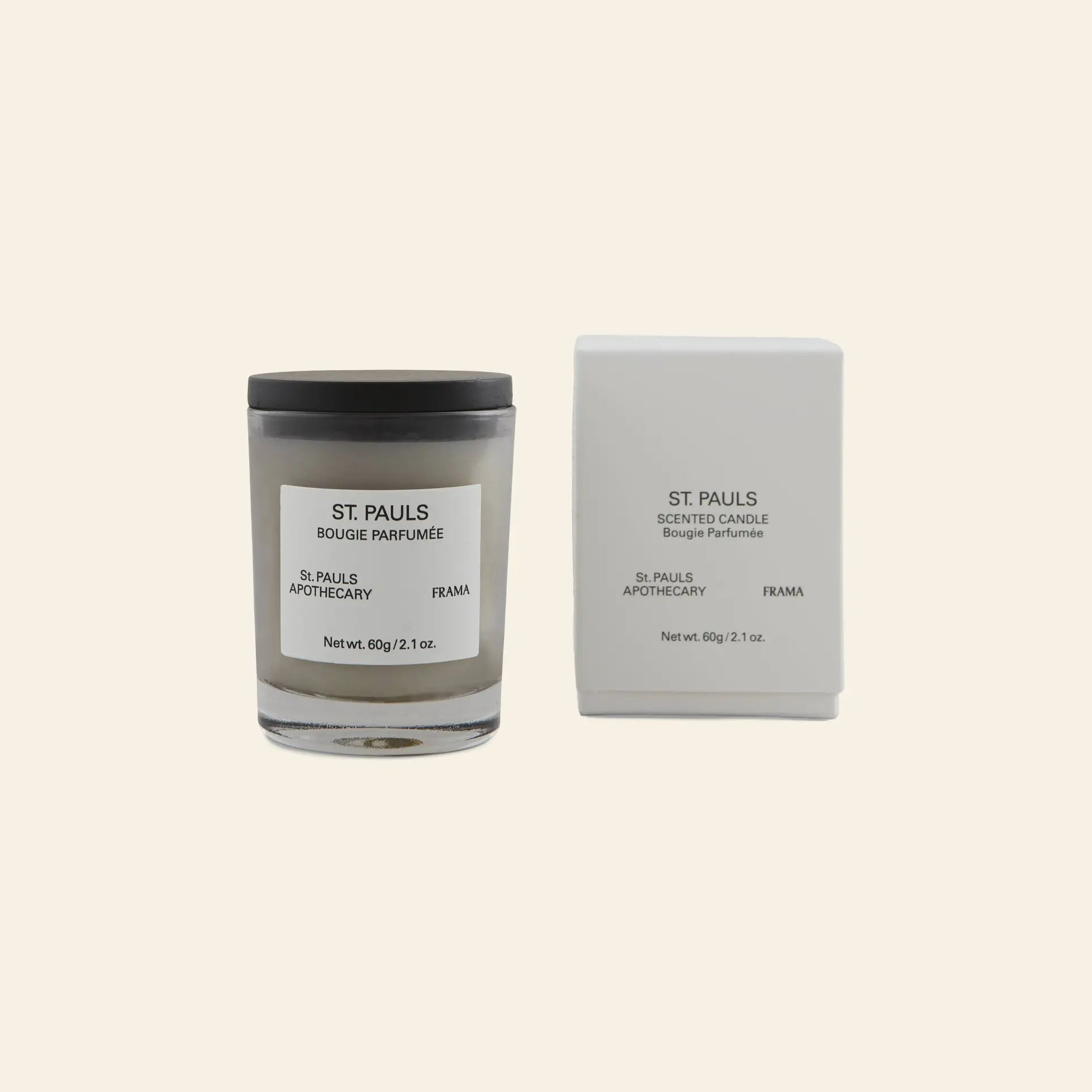 The FRAMA St. Pauls Scented Candle, 60g, sits next to its elegant white box on a beige background, highlighting the brands signature evocative aroma.