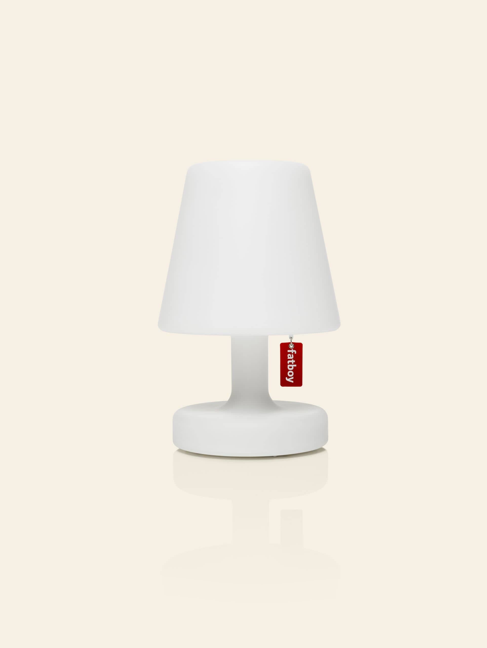 The Fatboy Edison the Petit is a small, modern white table lamp with a simple design and red Fatboy tag. Portable and stylish, it offers soft diffused light and is shown against a plain cream background.