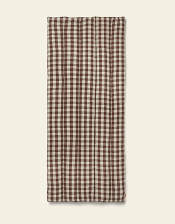 The Ferm Living Bothy Check Quilted Mattress features a brown and white gingham pattern, laid flat on a beige background—ideal for bringing rustic charm to your home decor.