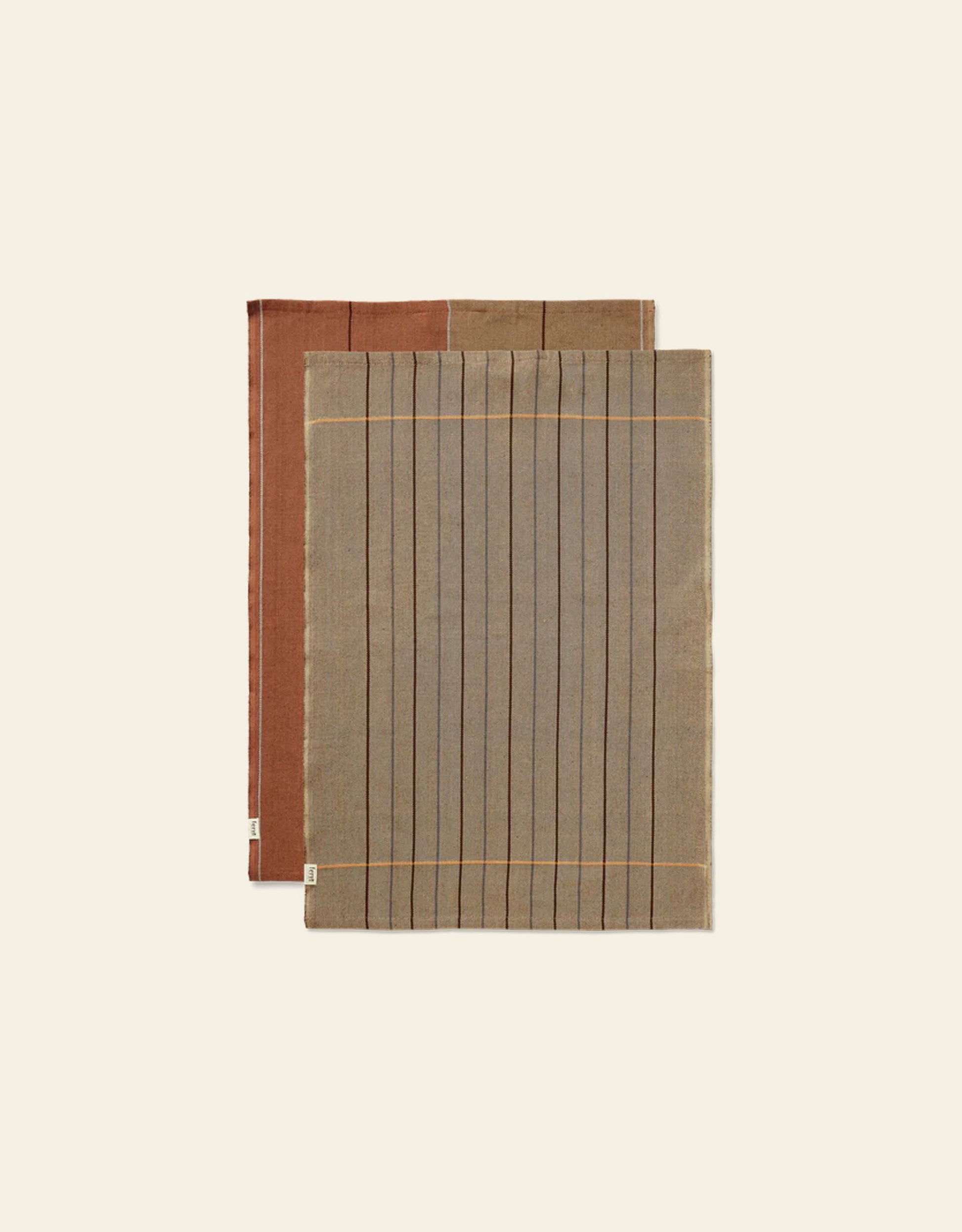 The Ferm Living Ito Tea Towel set includes two rectangular towels with a twill weave: one gray with black lines and beige borders, the other brown with subtle stripes—ideal kitchen textiles from Ferm Living.