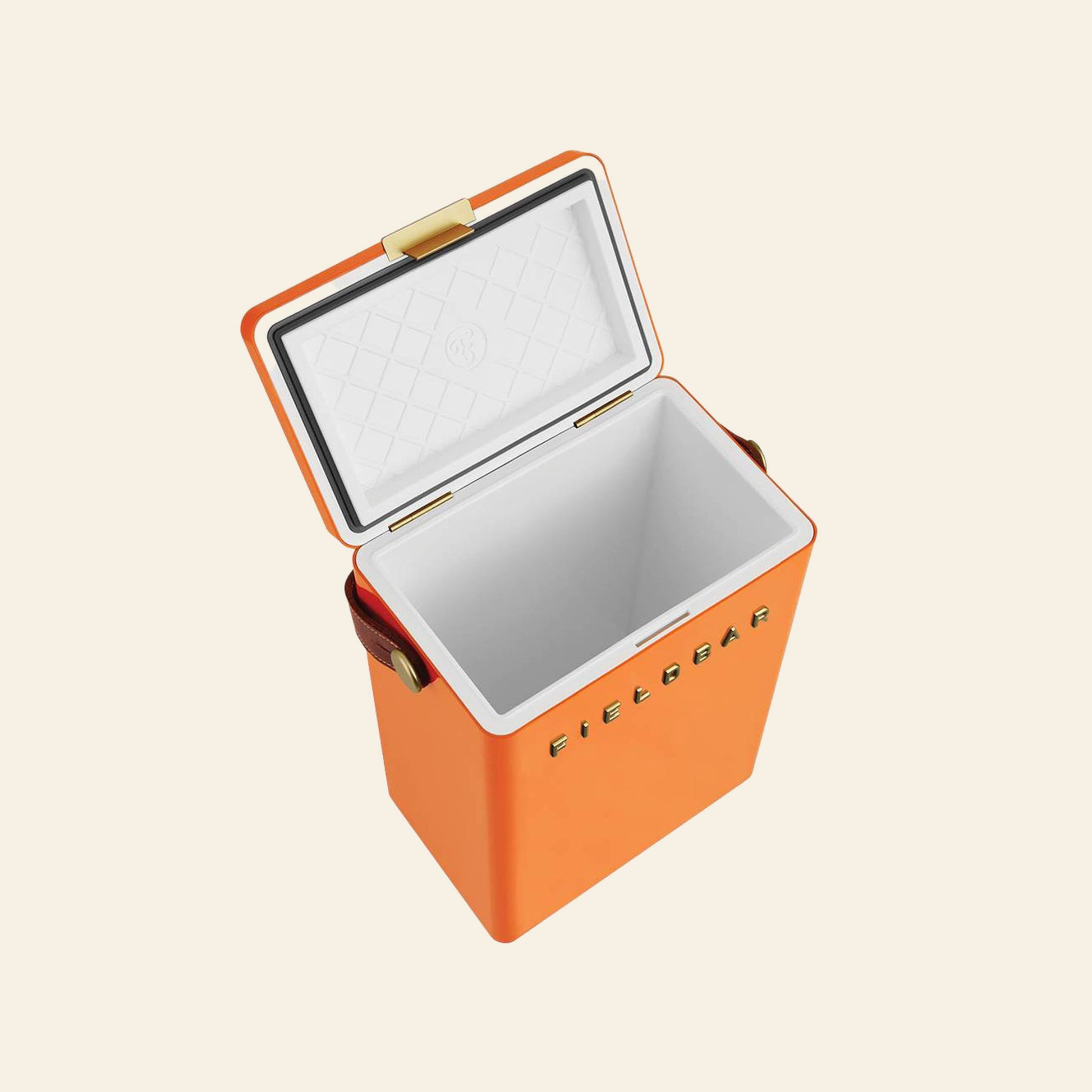 An orange rectangular Fieldbar Drinks Box by Fieldbar is shown with its lid open, revealing a white insulated interior. FIELDBAR is embossed on the front, and it features brass hardware plus brown handles for optimal cooling performance.