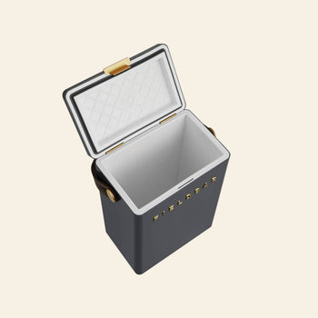 The Fieldbar Drinks Box by Fieldbar features a dark gray body, white diamond-patterned lid, and gold latch and handles. “FIELDBAR” is printed in gold on the side, making this ice box both stylish and high performing.