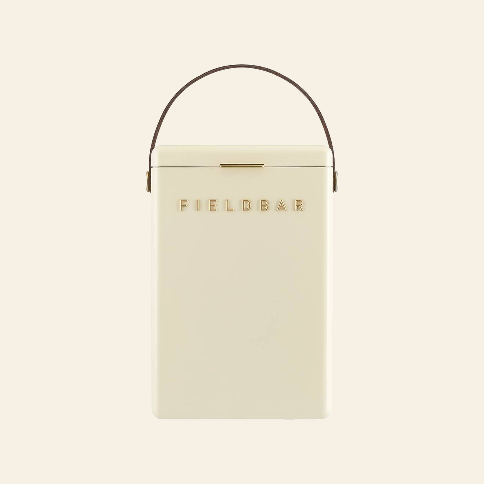A cream-colored rectangular Fieldbar Drinks Box by FIELD BAR, featuring a brown handle and gold FIELD BAR lettering on the front, displayed against a plain light background.