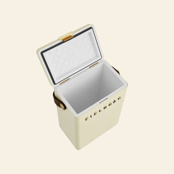 The Fieldbar Drinks Box, shown open in a cream color with gold accents and a quilted interior, stands out against a plain light background, showcasing the stylish Fieldbar design and superior thermal performance.