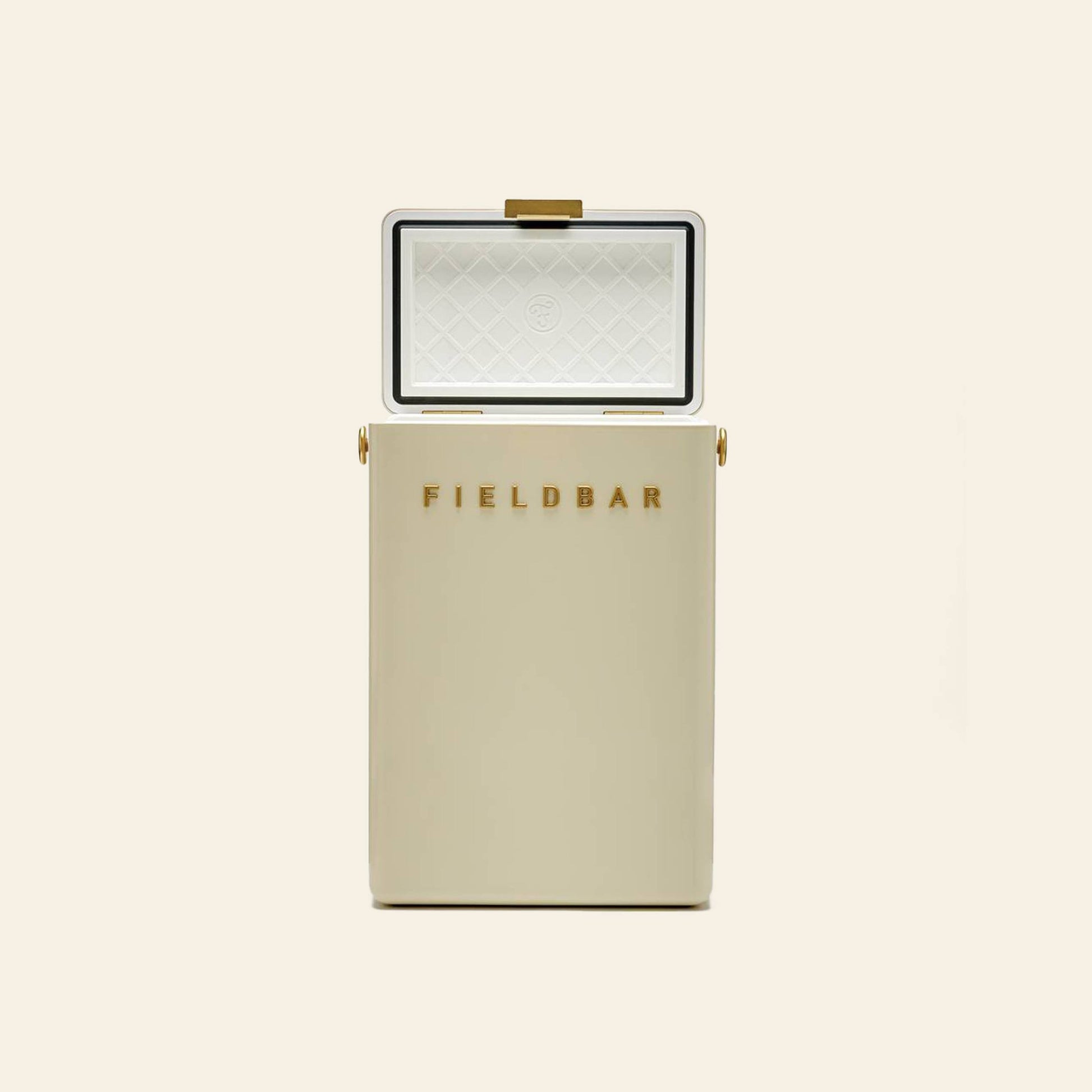 A cream-colored Fieldbar Drinks Box by Fieldbar stands upright with its lid open, showing a diamond-patterned white interior and gold FIELDBAR lettering on the front. The plain, light background highlights this ice box’s excellent thermal performance.