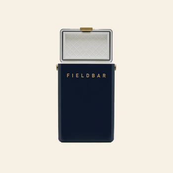 A Fieldbar Drinks Box by Fieldbar in navy blue with a white interior and gold accents is displayed open against a plain light background.