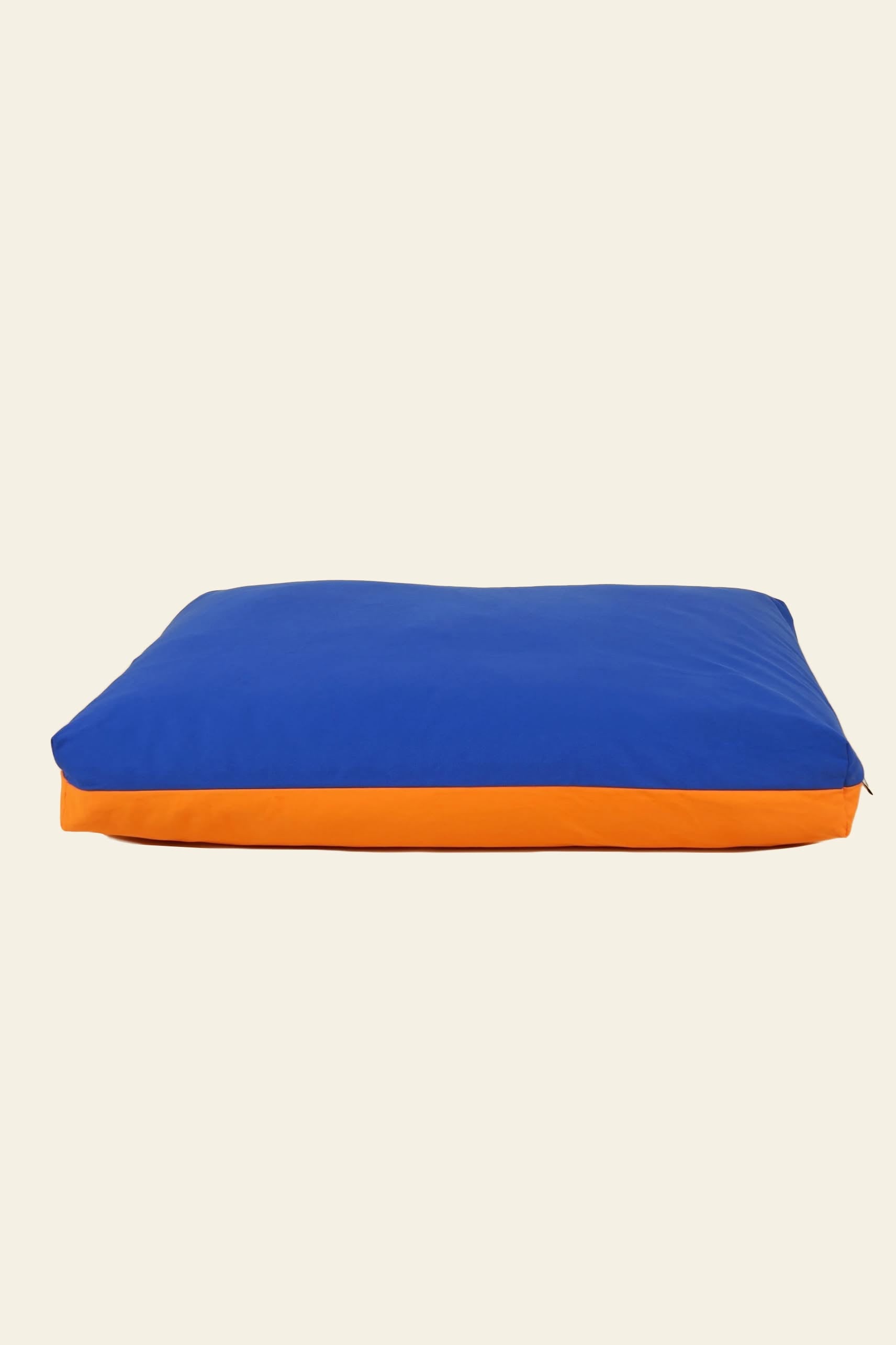 The Good Chonk Cloud Kapok Dog Bed by Good Chonk features a rectangular shape, blue top, orange side, eco-friendly kapok fill, and a 100% cotton canvas cover, displayed on a plain light background.