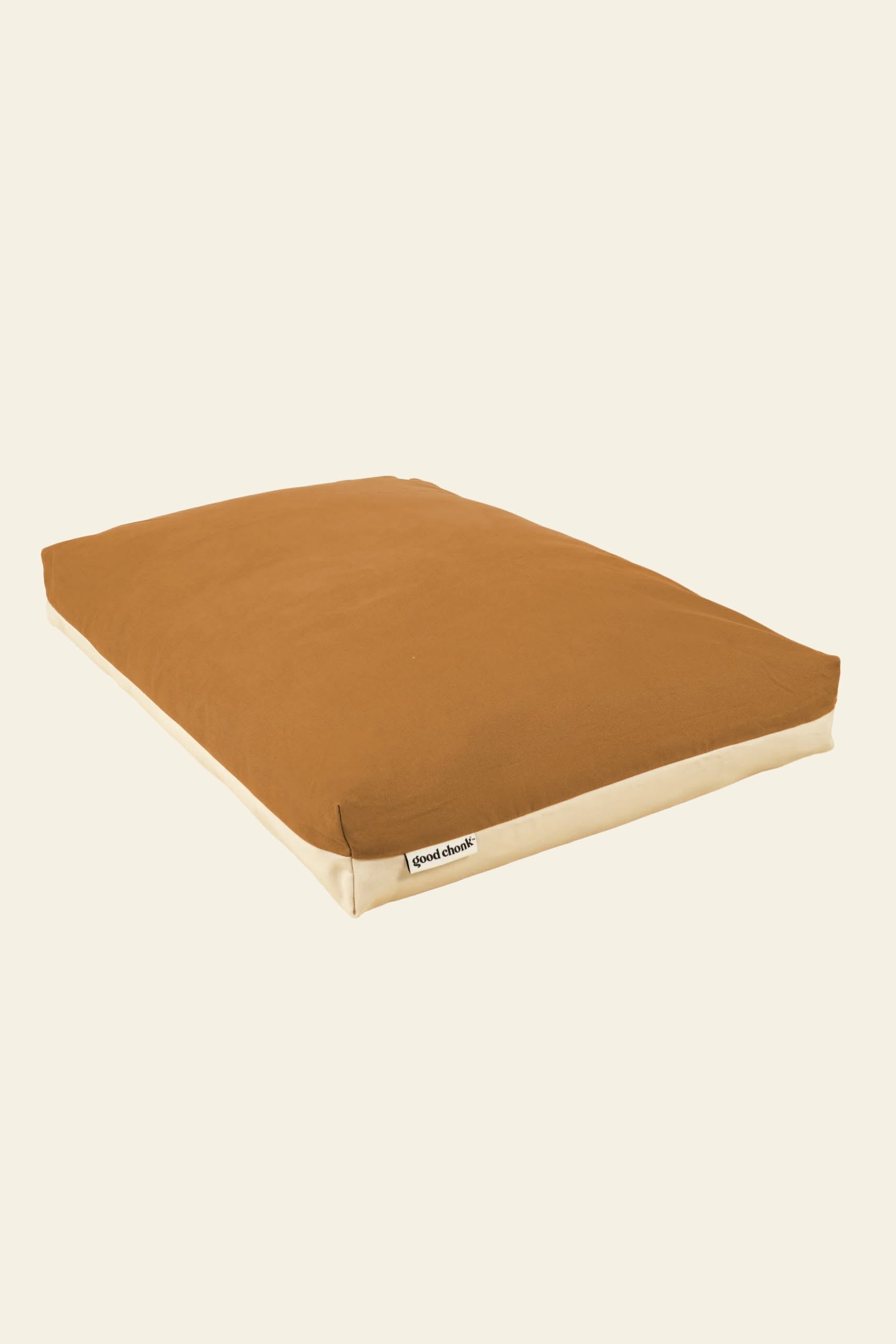 The Good Chonk Cloud Kapok Dog Bed by Good Chonk is a rectangular brown and beige bed with a soft, cushioned eco-friendly kapok fill, a 100% cotton canvas cover, and a small GoodLands label on one side, shown against a plain cream background.