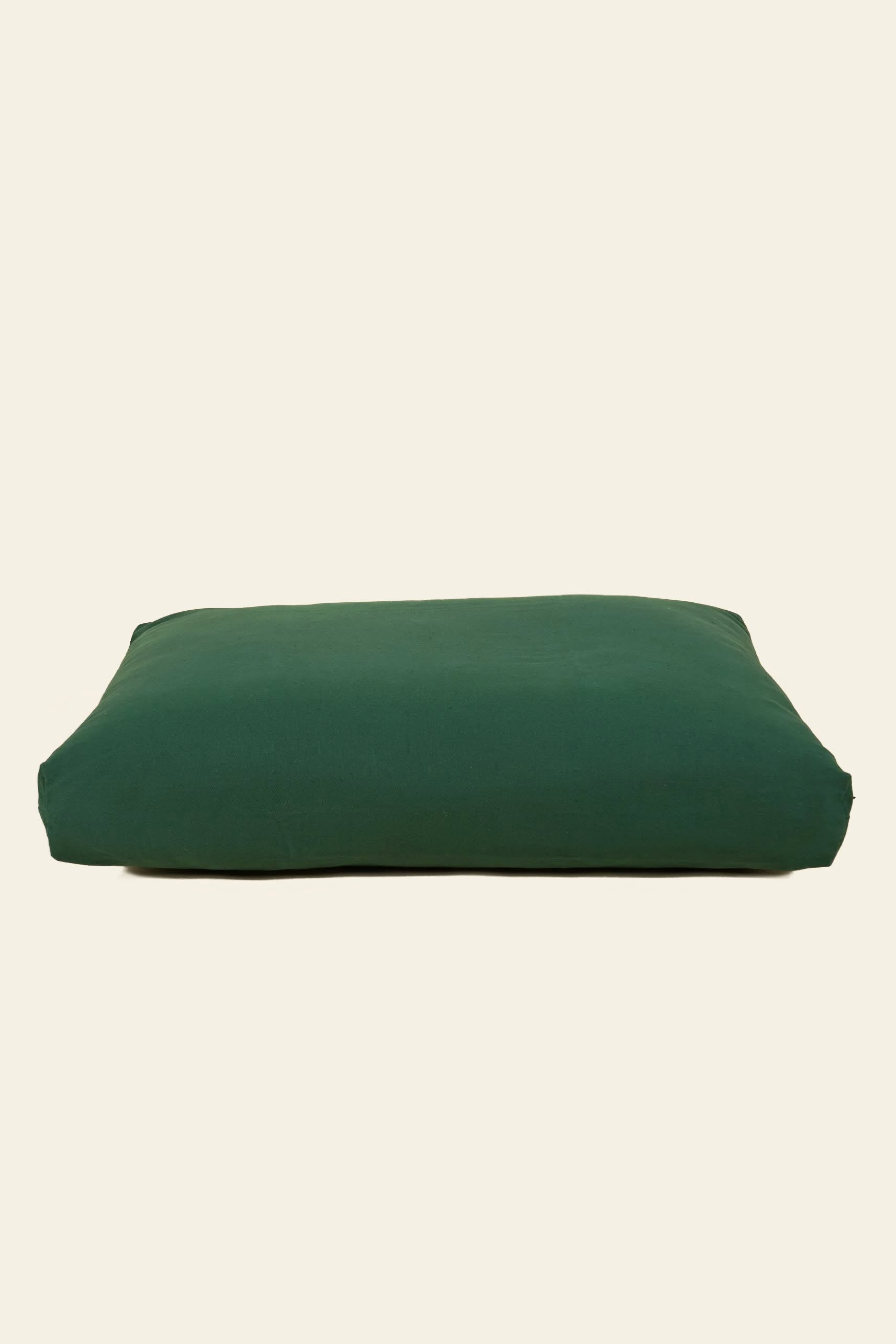 The Good Chonk Cloud Kapok Dog Bed by Good Chonk, featuring a rectangular dark green 100% cotton canvas cover, is shown on a plain light beige background.
