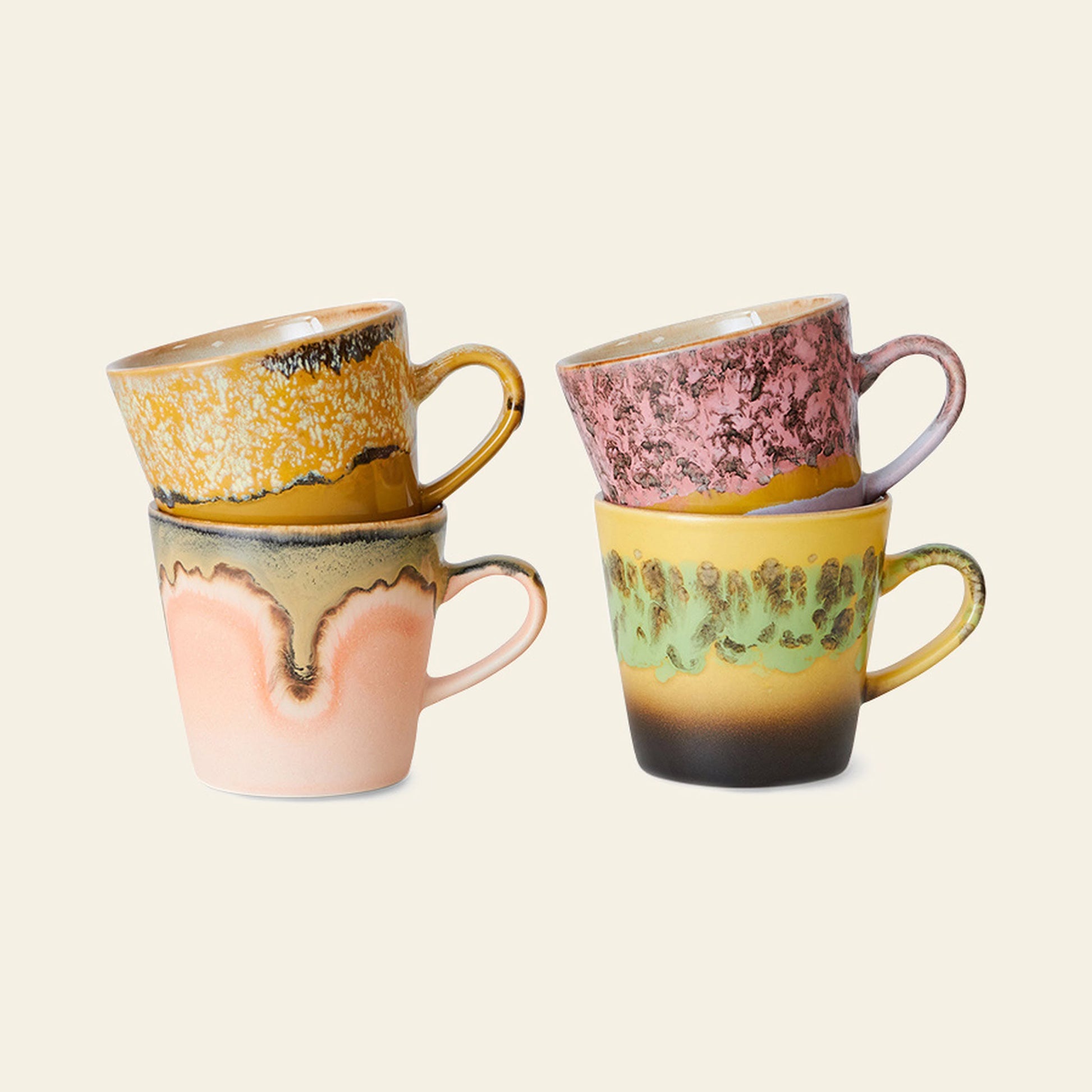 Four HKLIVING 70s Ceramics: Americano Mugs, Set of 4, are stacked in pairs against a beige background. Each mug by HKLIVING has a unique 70s-inspired glaze in yellow, pink, green, and brown tones.