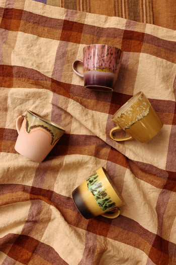 The HKLIVING 70s Ceramics: Americano Mugs, Set of 4, features hand-glazed stoneware mugs in pink, yellow, green, and earthy tones with unique retro-inspired patterns and tonal designs.