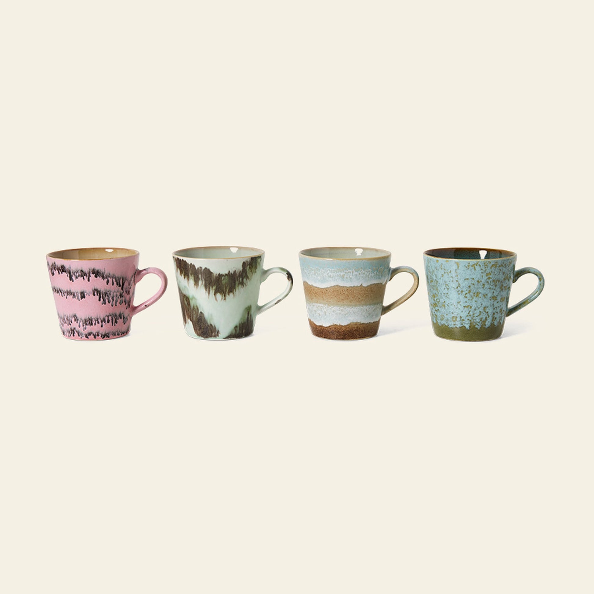 The HKLIVING 70s Ceramics: Cappuccino Mugs, Set of 4, by HKLIVING, features hand-glazed mugs in pink and brown, green and brown, blue and brown stripes, and blue with green speckles arranged on a light surface.
