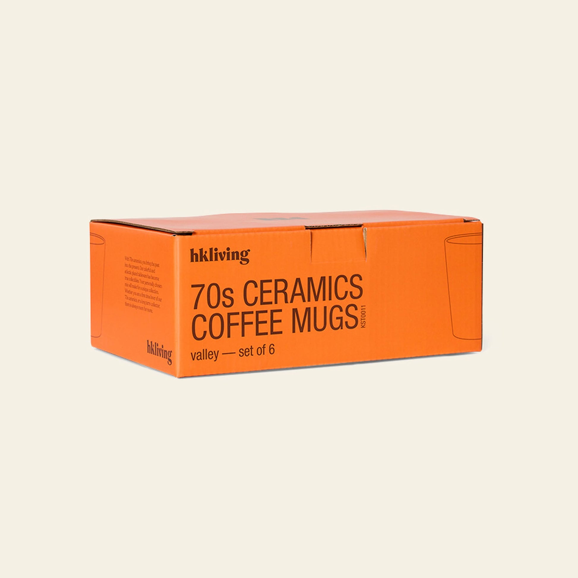 An orange box labeled HKLIVING 70s Ceramics: Coffee Mugs, Set of 6 is displayed against a plain light background, featuring simple mug line drawings and evoking the handcrafted glazing style of 70s ceramics.