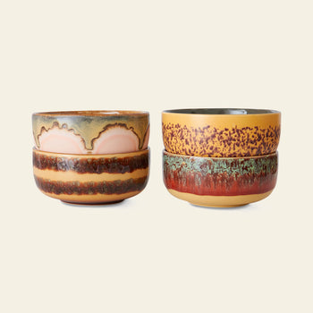 The HKLIVING 70s Ceramics: Dessert Bowls, Set of 4, features two stacks with earthy-toned, textured glazes—pink and brown shades on the left, yellow, red, and green accents on the right—set against a light background.
