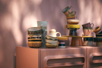 HKLIVING 70s Ceramics: Dessert Bowls, Set of 4, with textured retro patterns, are stacked on a light pink cabinet as soft sunlight and shadows highlight their colorful design.
