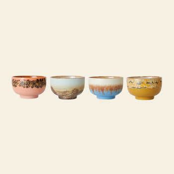 The HKLIVING 70s Ceramics Noodle Bowls Set of 4 features unique, colorful patterns—pink with brown, light blue with textured beige, blue with brown glaze, and yellow mottled—set against an off-white background inspired by retro ceramics.