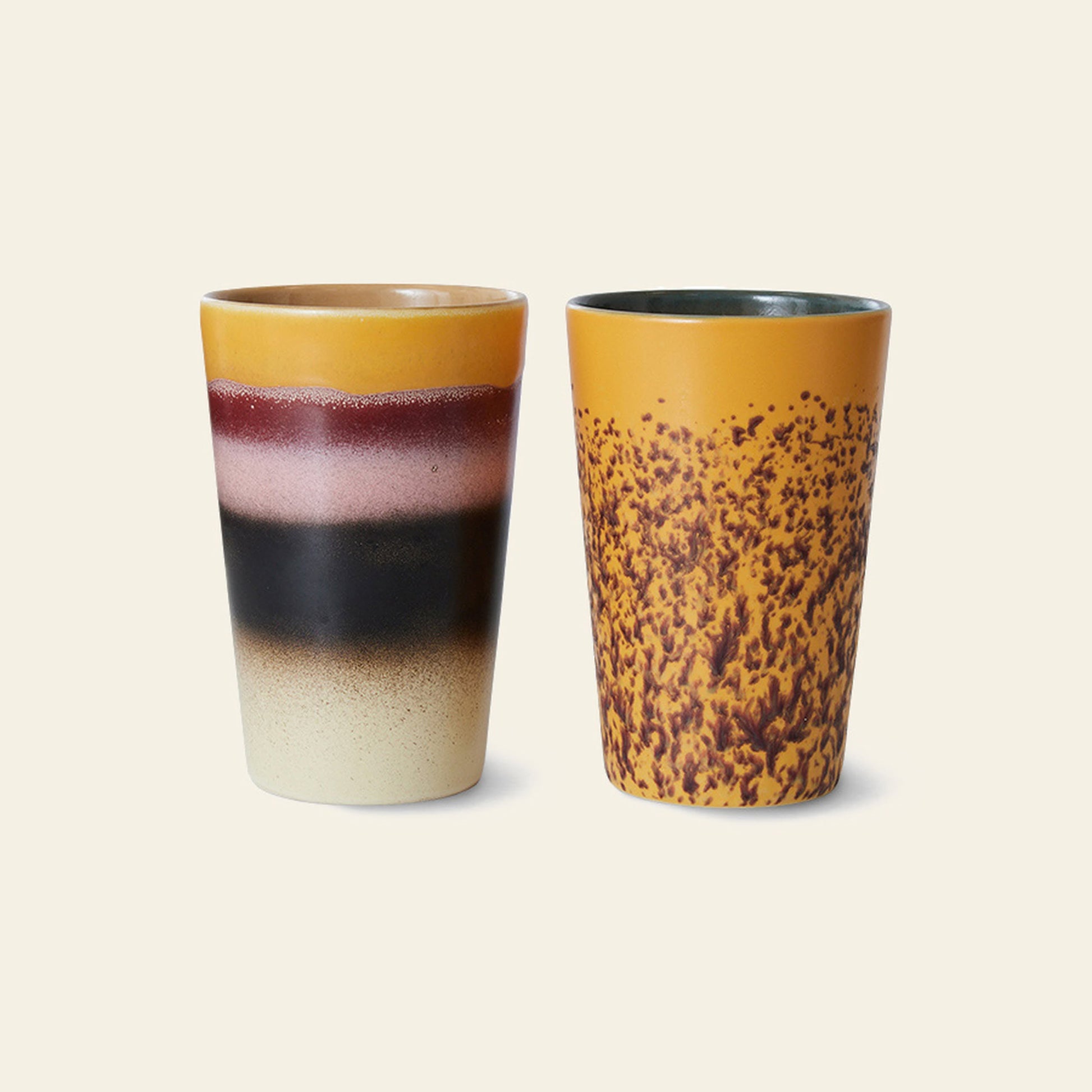 HKLIVING 70s Ceramics: Tea Mugs, Set of 2—one with retro yellow, pink, black, and cream stripes, the other with a yellow base and brown speckles—are set against an off-white background.