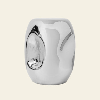 The HKLIVING Currents Chrome Side Table by HKLIVING is a reflective, silver, cylindrical piece with a polished chrome finish, smooth rounded surface, and an indented oval detail—ideal for contemporary interiors.
