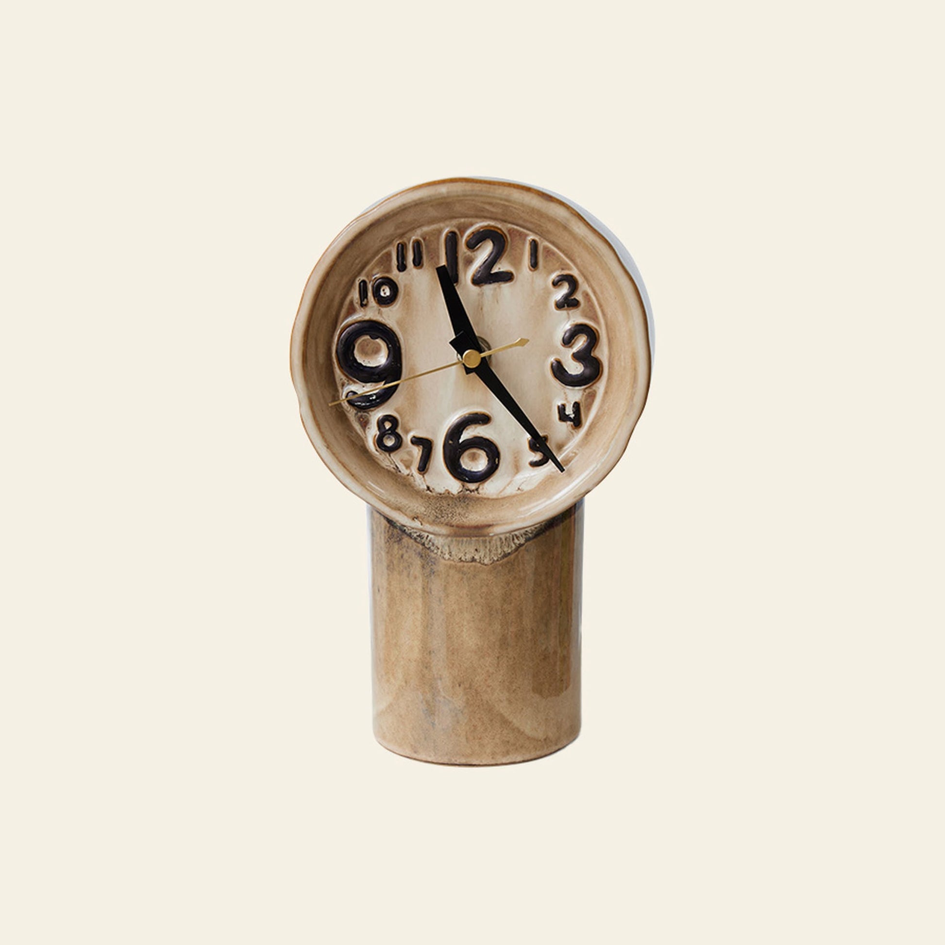 The HKLIVING Retro Ceramic Clock - Cream features distorted, melted numbers and a warped face on a cylindrical base, highlighting its vintage-inspired design by HKLIVING against an off-white backdrop.