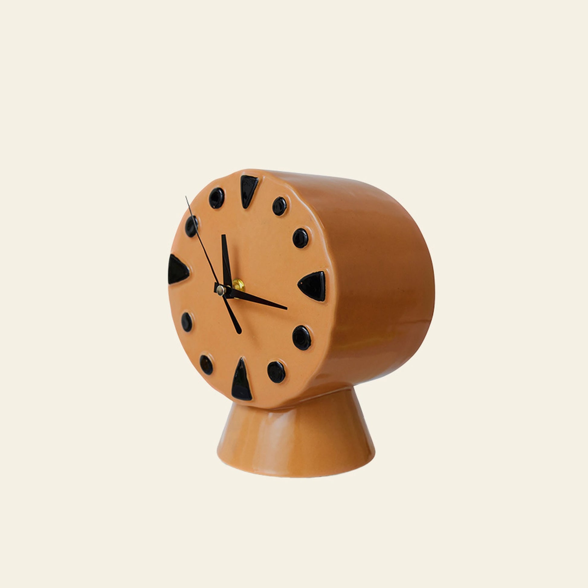 The HKLIVING Retro Ceramic Clock - Peach features a modern design with black triangular markers and hands on a matching pedestal base, blending vintage flair and traditional ceramic craft against a plain light backdrop.