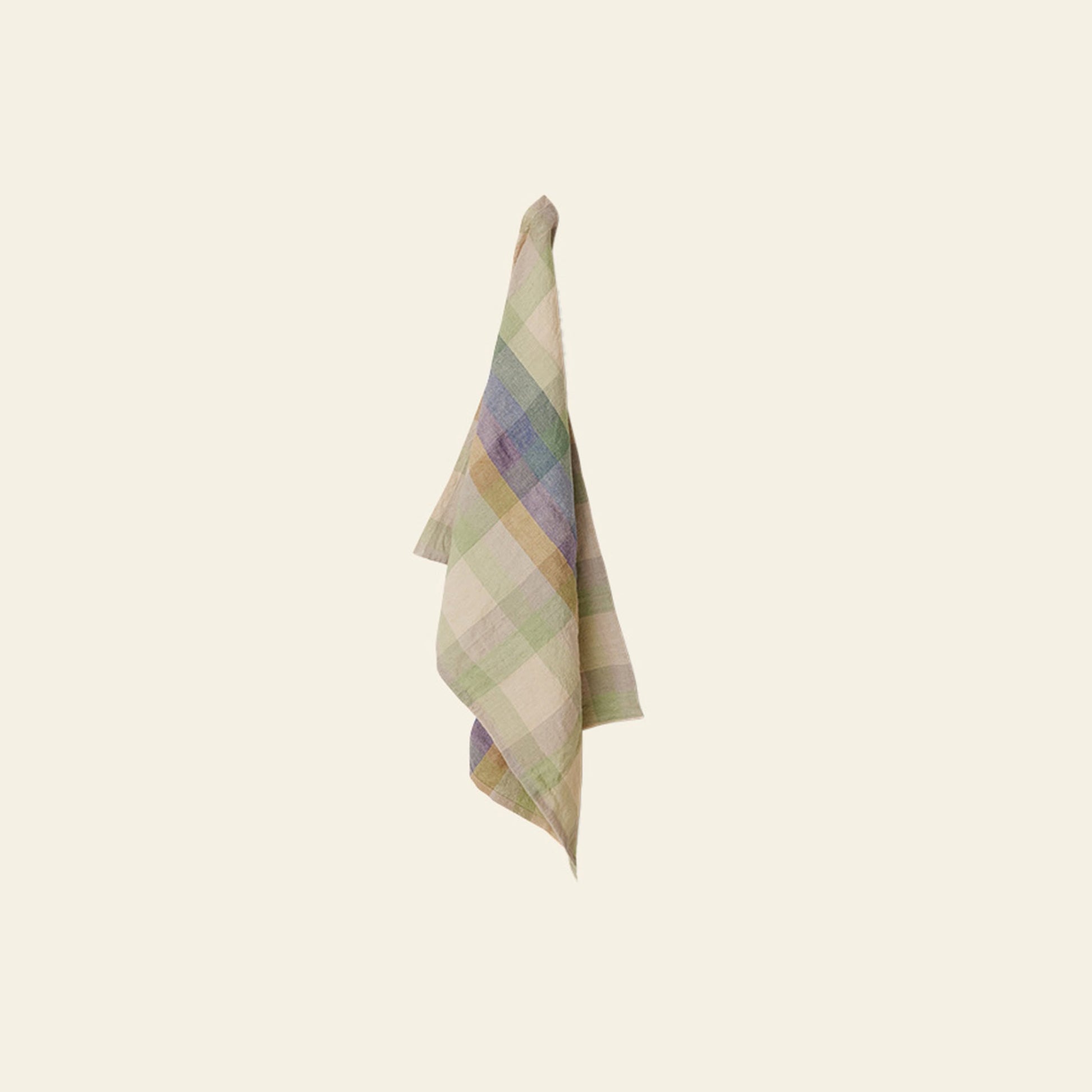 The HKLIVING Vida Check Tea Towel features a premium blend with pastel green, blue, and beige checks, and is shown hanging on a neutral light-colored wall.